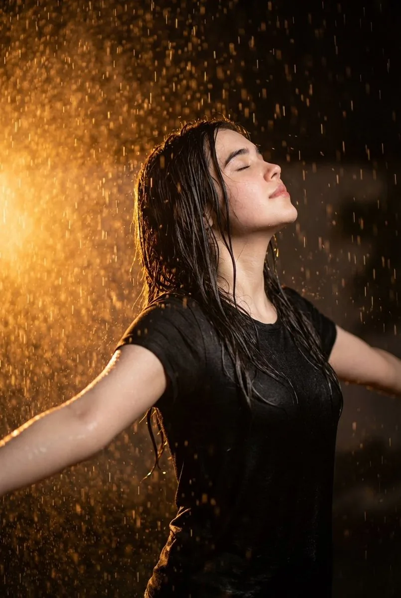Cinematic portrait of woman in heavy rain at night reference