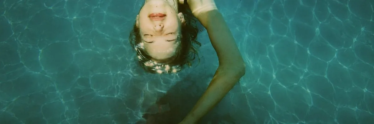 Anonymized Swimmer in Teal Pool reference
