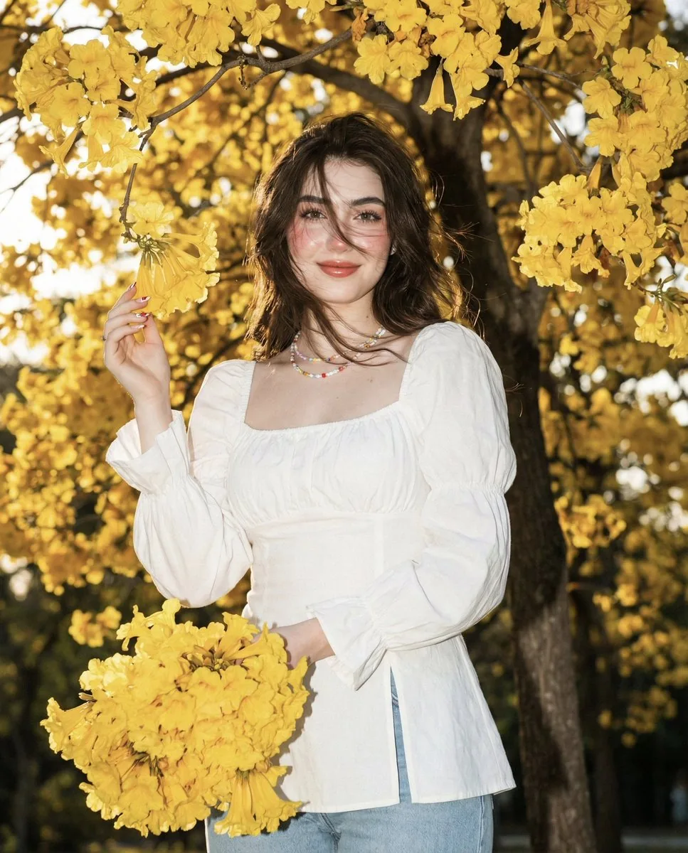 Asian Woman Portrait with Golden Trumpet Flowers and Direct Flash - Nano Banana Pro AI Prompt for Social Media Post reference